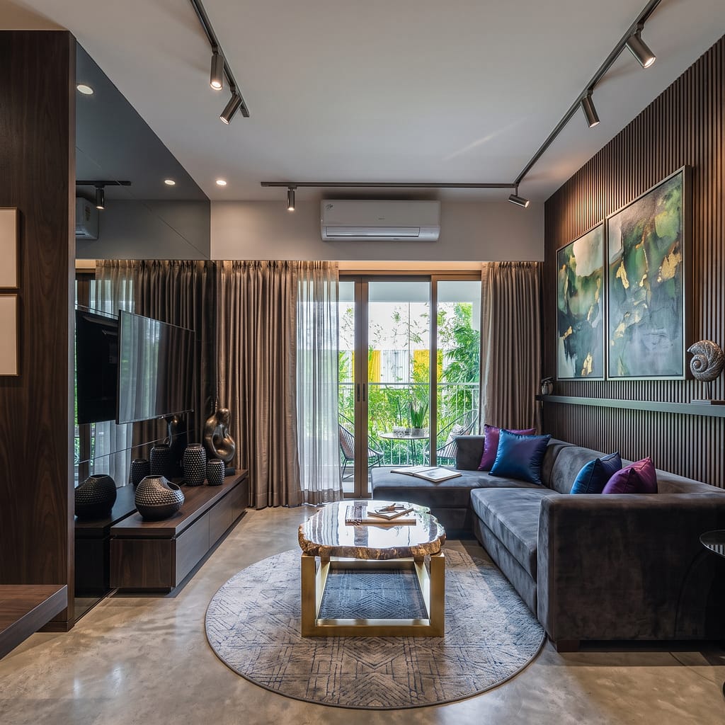 Best Interior Designers in Kolkata for Modern Home Makeovers (2026 Guide) 2 Walnut TV console with bronze sculpture and ceramic vases in a designer living room in Kolkata