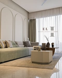 Interior Designer in New Alipore 4 Modern 3BHK living room in Kolkata with arch wall panels, sage green and grey sofa, designed by Estate Lookup Interiors